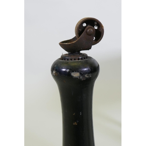 1196 - A pair of Victorian ebonised stools, with shaped friezes, raised on turned supports with metal casto... 