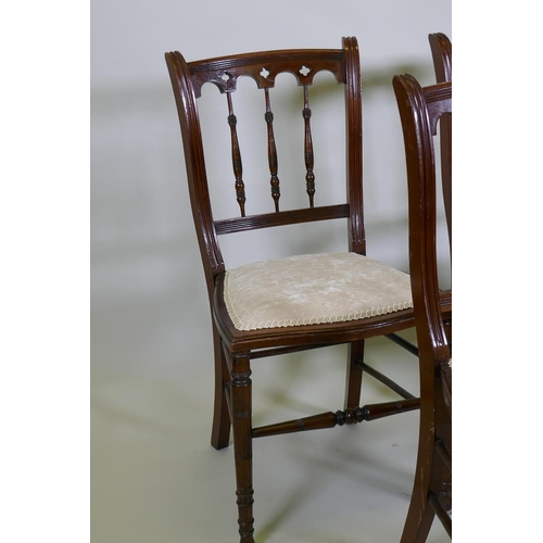 1198 - Four C19th beechwood and walnut side chairs with Gothic style backs, raised on turned tapering suppo... 