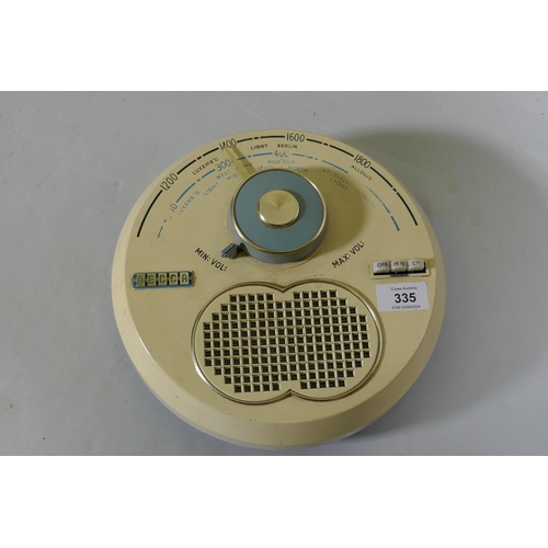 325 - A Decca Model TPW70 MW/LW transistor radio, 26cm diameter