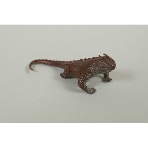 100 - A Japanese style bronze okimono horned lizard, 7cm long