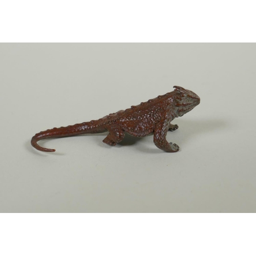 100 - A Japanese style bronze okimono horned lizard, 7cm long