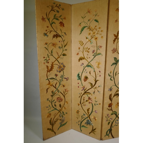 1002 - An antique Arts & Crafts style four fold screen, with embroidered crewel work designs of flowers... 