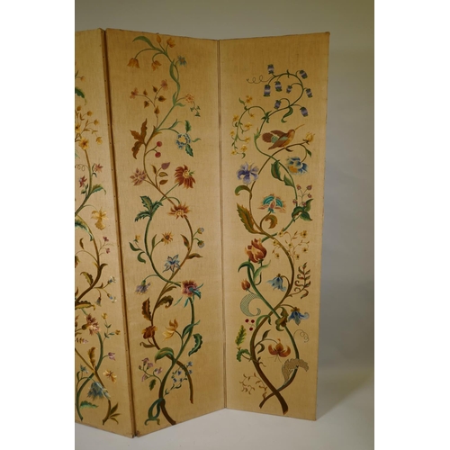 1002 - An antique Arts & Crafts style four fold screen, with embroidered crewel work designs of flowers... 