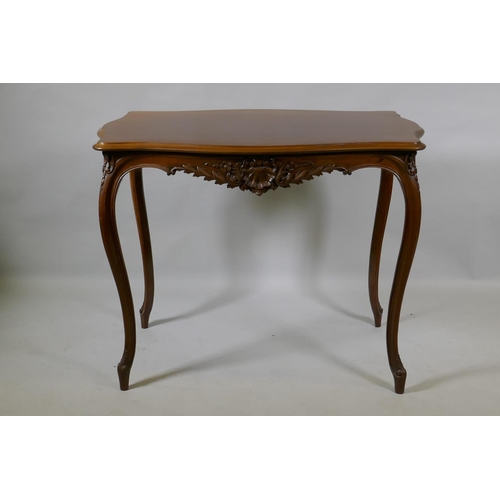 1003 - An early C19th French walnut serpentine shaped top centre table, with carved frieze, raised on slend... 