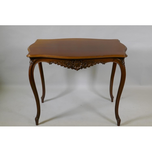 1003 - An early C19th French walnut serpentine shaped top centre table, with carved frieze, raised on slend... 