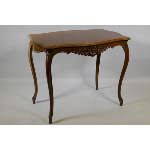 1003 - An early C19th French walnut serpentine shaped top centre table, with carved frieze, raised on slend... 