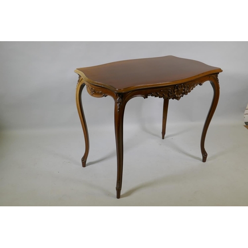 1003 - An early C19th French walnut serpentine shaped top centre table, with carved frieze, raised on slend... 