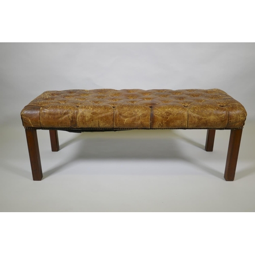 1005 - A Victorian leather Chesterfield bench, 110 x 40cm, 42cm high