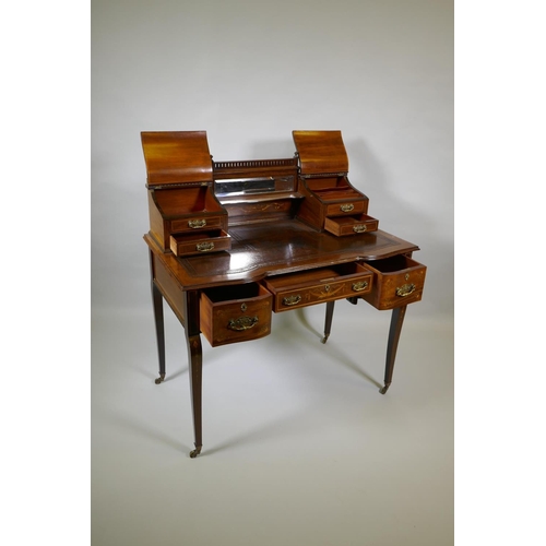 1006 - A Victorian inlaid mahogany inverted breakfront bonheure de jour, with pierced brass gallery top and... 