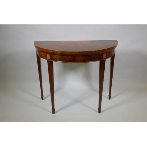 1007 - A Georgian mahogany demi lune card table, fiddle back mahogany with satinwood inlaid fan and crossba... 