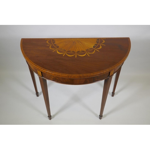 1007 - A Georgian mahogany demi lune card table, fiddle back mahogany with satinwood inlaid fan and crossba... 