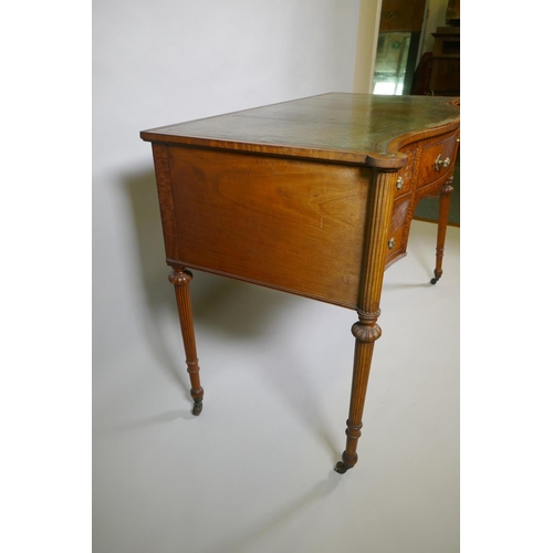 1009 - A Victorian satinwood serpentine front five drawer kneehole dressing table, with inset leather top, ... 