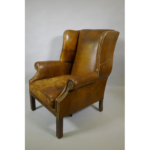 1012 - A leather wingback armchair