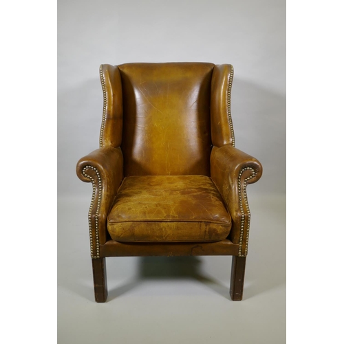 1012 - A leather wingback armchair