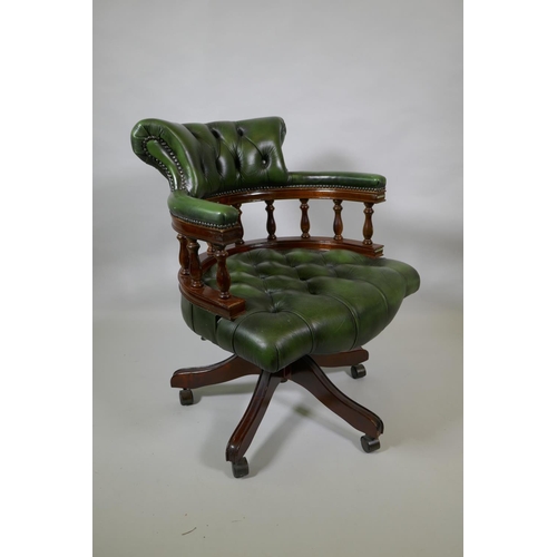 1017 - A buttoned leather swivel captain's chair