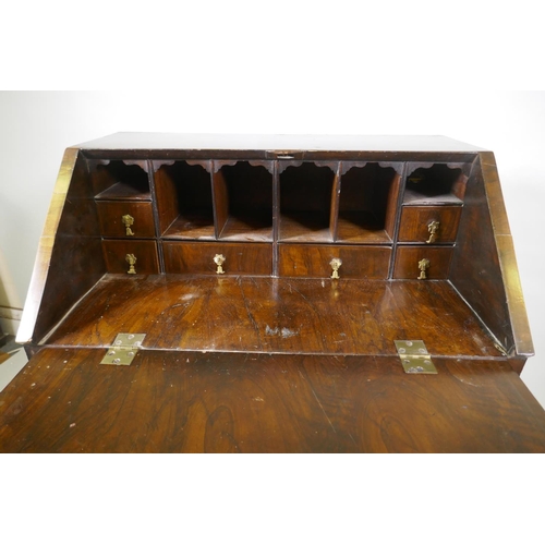 1022 - A Georgian style walnut kneehole bureau, the fall front with fitted interior over a single drawer an... 