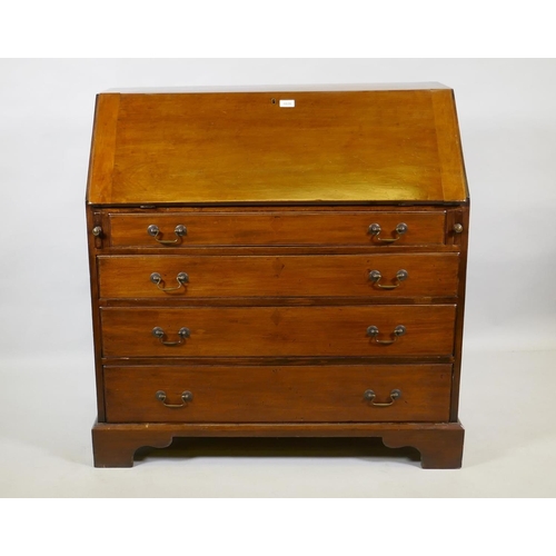 1028 - A Georgian mahogany bureau, the fall front with fitted interior over four long drawers with brass sw... 