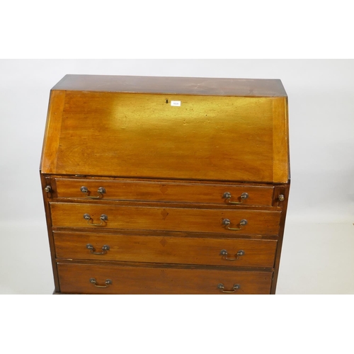 1028 - A Georgian mahogany bureau, the fall front with fitted interior over four long drawers with brass sw... 