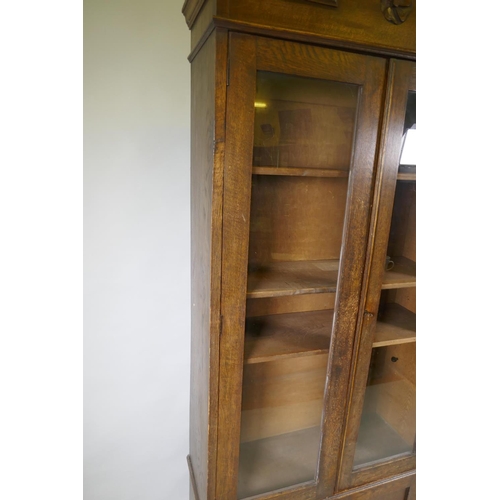 1029 - A C19th oak cabinet with arched top and two glazed doors over two cupboards, 90 x 30 x 210cm