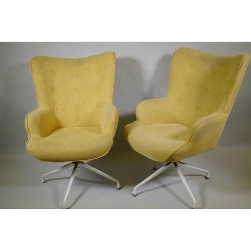 1032 - A pair of reclining swivel armchairs on spider legs