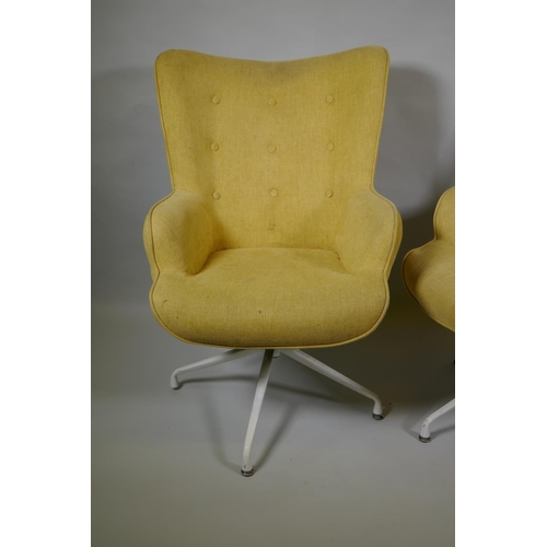 1032 - A pair of reclining swivel armchairs on spider legs