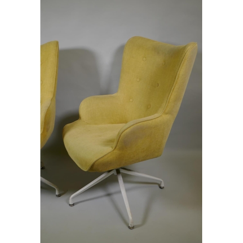 1032 - A pair of reclining swivel armchairs on spider legs