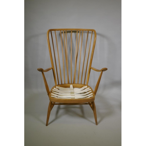 1034 - An Ercol beech and elm Windsor tall back armchair Model 478, and a similar Ercol model 334 armchair