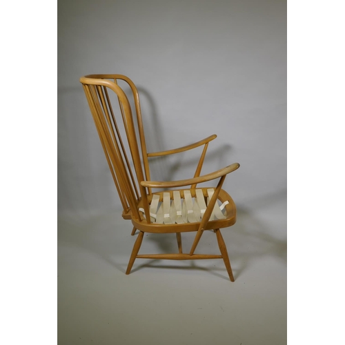 1034 - An Ercol beech and elm Windsor tall back armchair Model 478, and a similar Ercol model 334 armchair