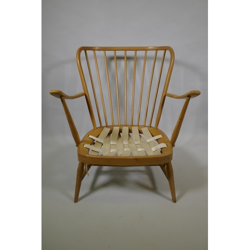 1034 - An Ercol beech and elm Windsor tall back armchair Model 478, and a similar Ercol model 334 armchair