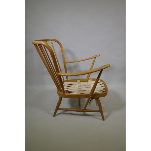 1034 - An Ercol beech and elm Windsor tall back armchair Model 478, and a similar Ercol model 334 armchair