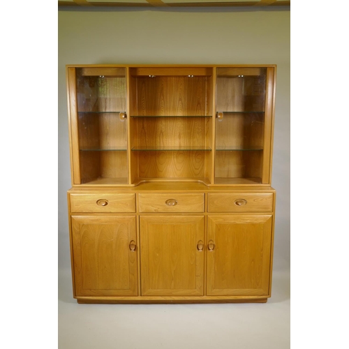 1035 - An Ercol elm Windsor high sideboard with two glazed doors to the upper section, and three drawers ov... 