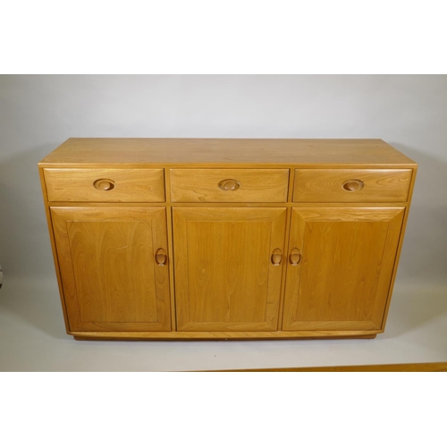 1035 - An Ercol elm Windsor high sideboard with two glazed doors to the upper section, and three drawers ov... 