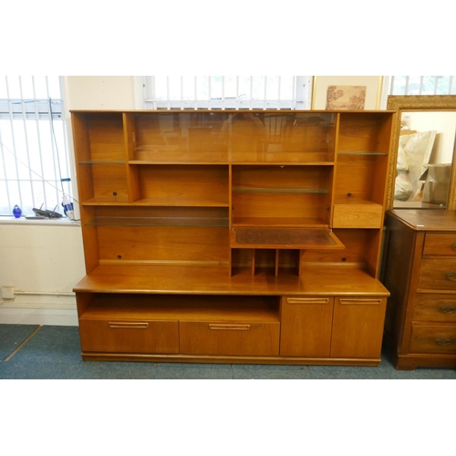 1037 - A mid century teak two section cabinet by Meredew, with sliding glass doors, open shelves and fall f... 