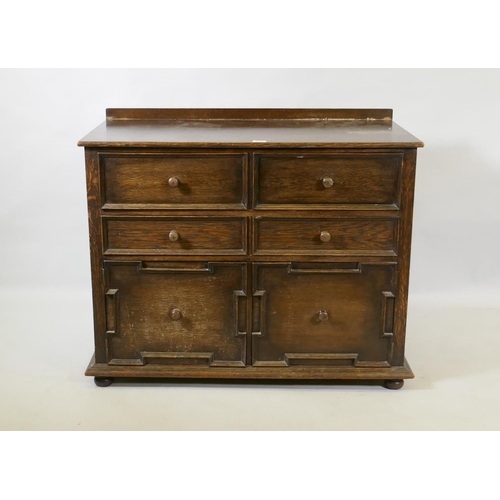 1038 - A Jacobean style oak cabinet, the top drawer with fold down front over a single drawer and two cupbo... 