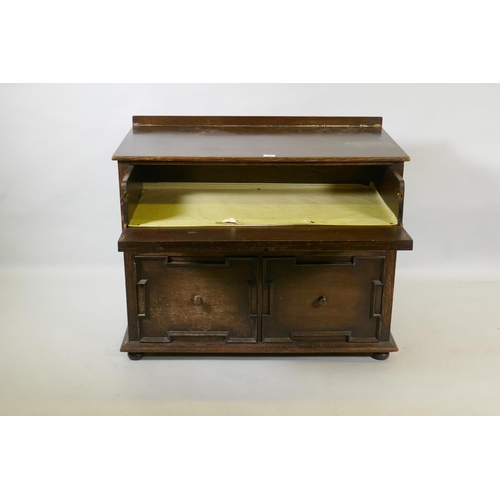 1038 - A Jacobean style oak cabinet, the top drawer with fold down front over a single drawer and two cupbo... 