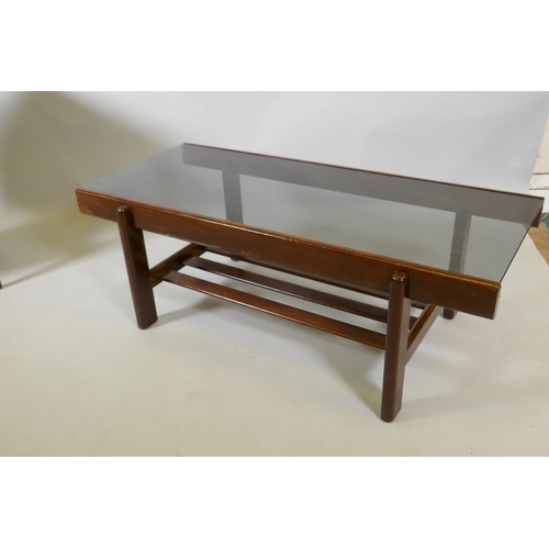 1041 - A mid century sapele wood two tier coffee table with tinted glass top, 100 x 44 x 36cm, and single d... 