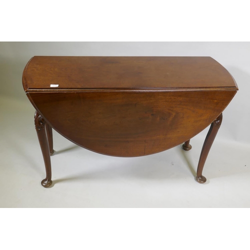 1049 - A Georgian mahogany drop leaf table, with oval top and shaped end frieze, raised on cabriole support... 