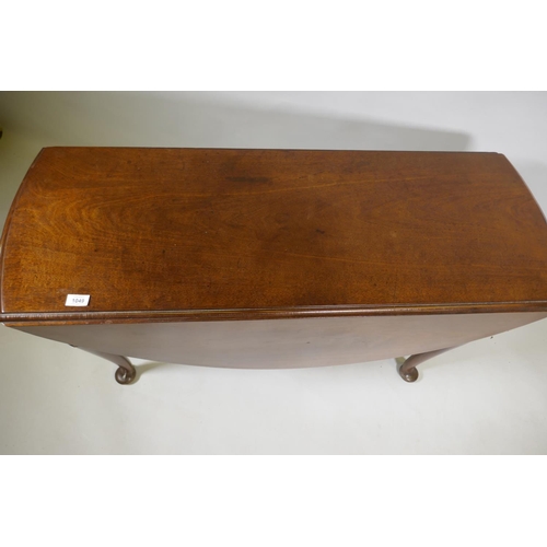 1049 - A Georgian mahogany drop leaf table, with oval top and shaped end frieze, raised on cabriole support... 