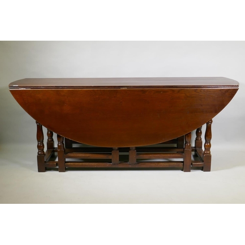 1054 - A large oak gateleg wake table, 200 x 152cm, 76cm high