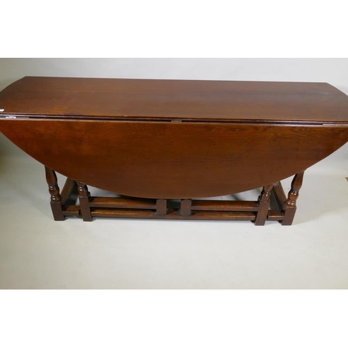 1054 - A large oak gateleg wake table, 200 x 152cm, 76cm high