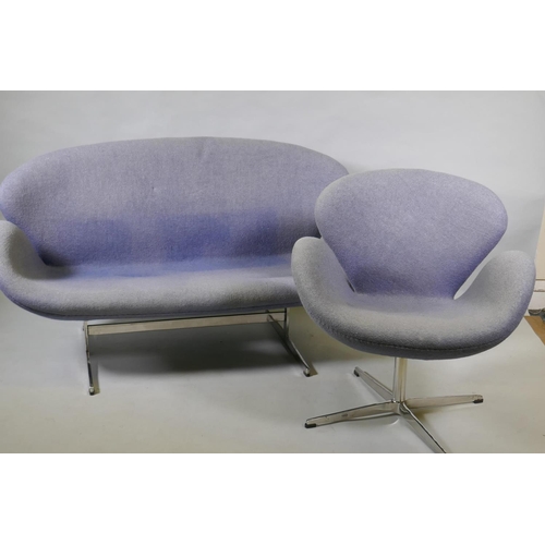 1059 - A contemporary egg shaped swivel chair with chrome supports, and matching two seater settee, 140cm w... 