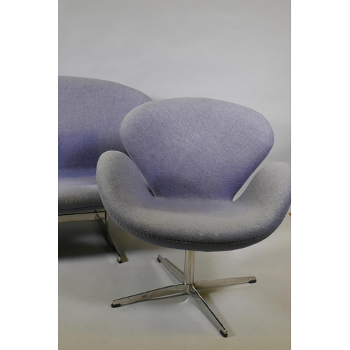 1059 - A contemporary egg shaped swivel chair with chrome supports, and matching two seater settee, 140cm w... 