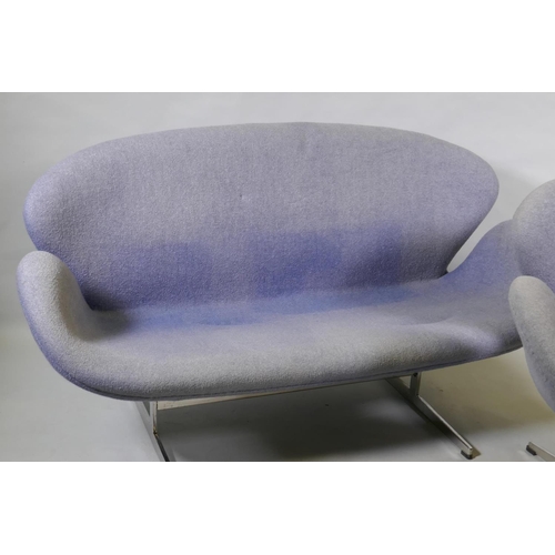 1059 - A contemporary egg shaped swivel chair with chrome supports, and matching two seater settee, 140cm w... 