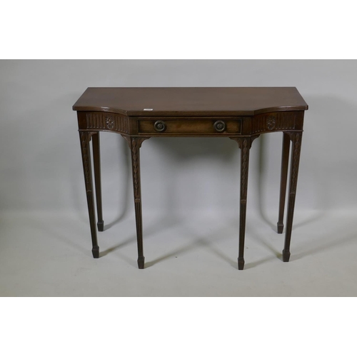 1060 - An Adam style mahogany breakfront side table with single drawer and carved fluted frieze, raised on ... 