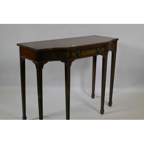 1060 - An Adam style mahogany breakfront side table with single drawer and carved fluted frieze, raised on ... 