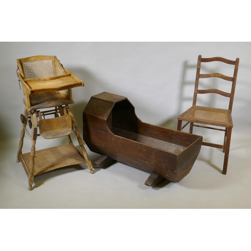 1061 - An antique oak cot, a child's metamorphic chair and a cane seated child's chair, cot 88cm long