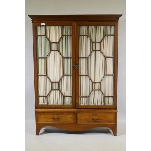 1066 - A Victorian mahogany bookcase with two astragal glazed doors over two drawers, raised on shaped supp... 