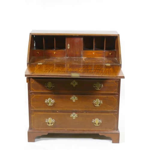 1068 - A Georgian inlaid mahogany bureau of small proportions, the fall front with fitted interior over fou... 