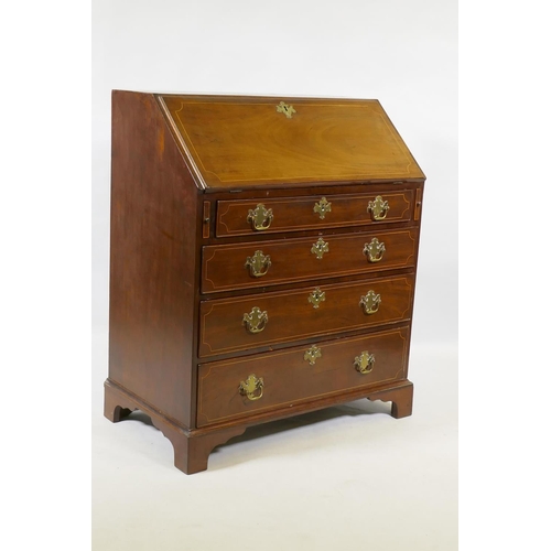 1068 - A Georgian inlaid mahogany bureau of small proportions, the fall front with fitted interior over fou... 