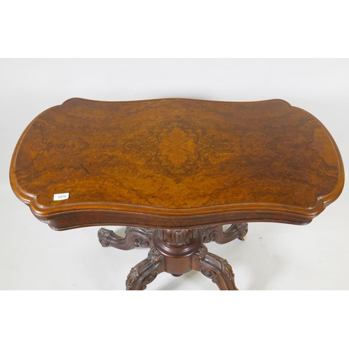 1070 - A Victorian burr walnut shaped top card table, raised on a carved and turned column and cabriole sup... 